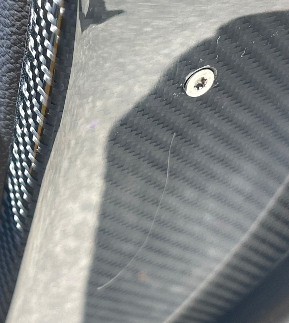 Door Plate with scratches around a screw and a longer scratch underneath it