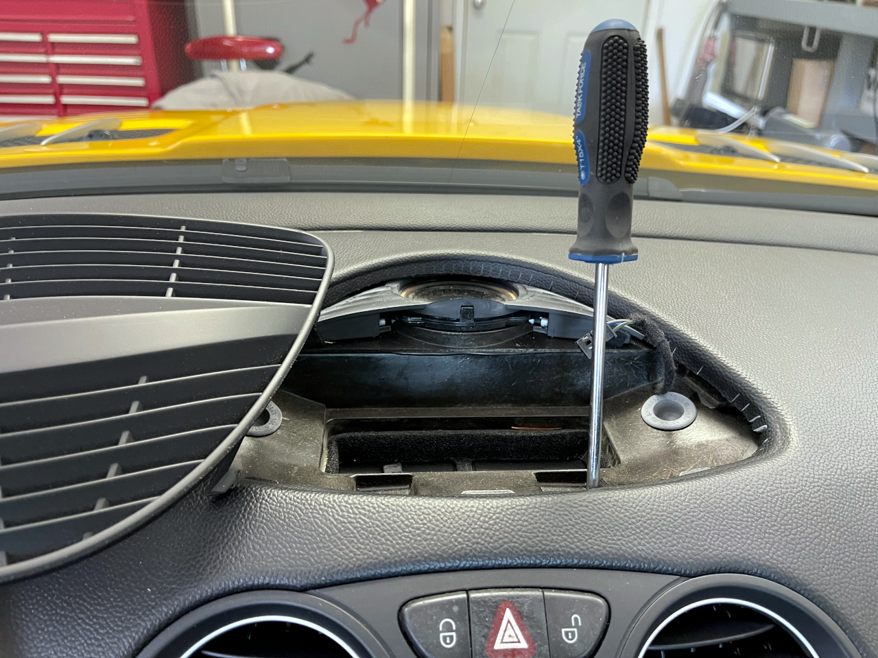 A screwdriver showing position of one of the screws
